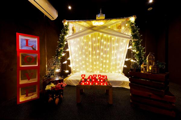 Step into a dreamy cabana adorned with drapes and soft lights for an enchanting movie night experience.