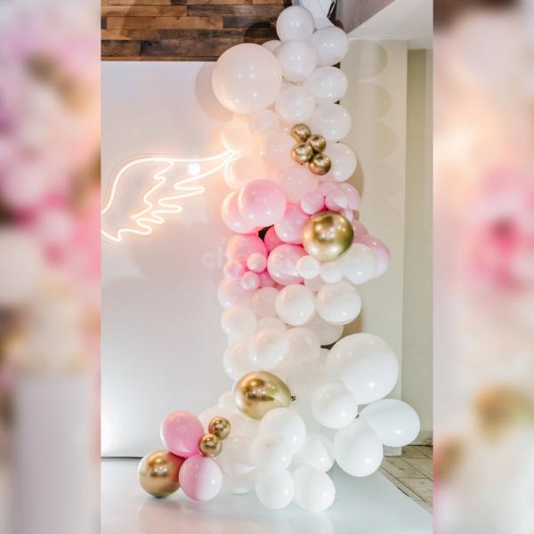Capture the warmth of the baby shower celebration with exquisite decor, showcasing disco lights, round tables, and ribbons, ensuring a memorable and delightful experience.