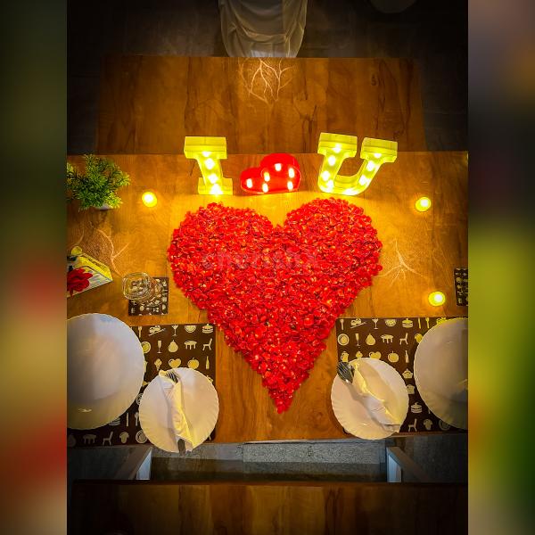 The setup also comes with a beautifully decorated table with rose petals and "I Love You" led letters.