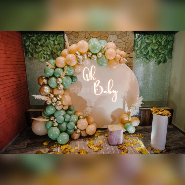 A delightful surprise baby shower setup featuring a Ring Stand adorned with pastel peach flex,