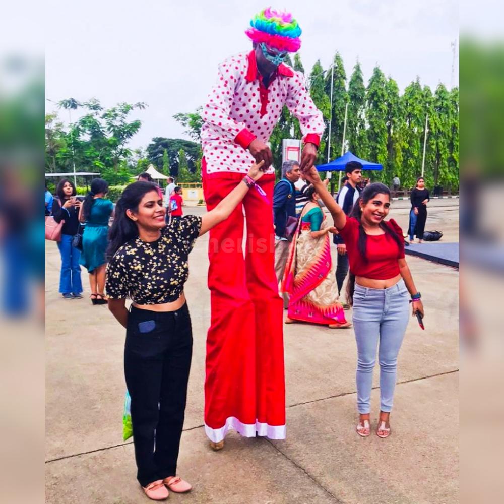 Experience the magic of towering stilt walkers bringing whimsy and wonder to your event with delightful decorations.
