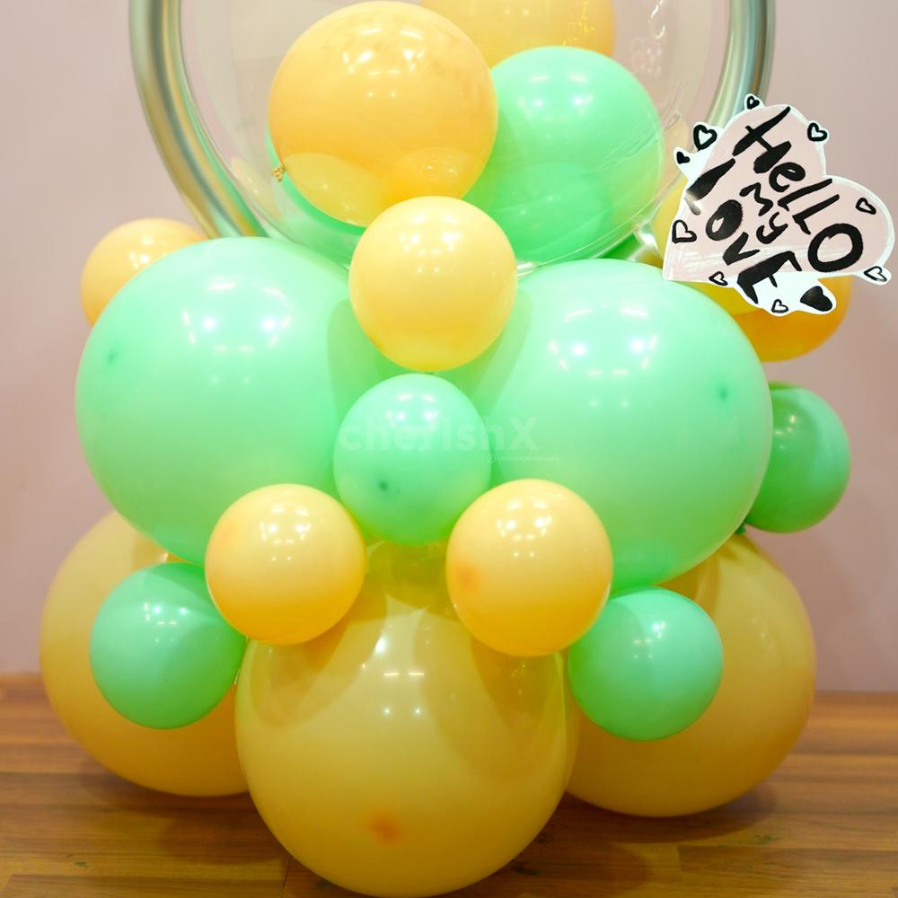 A balloon bouquet featuring 25 Apricot Vintage and Pastel Green Balloons