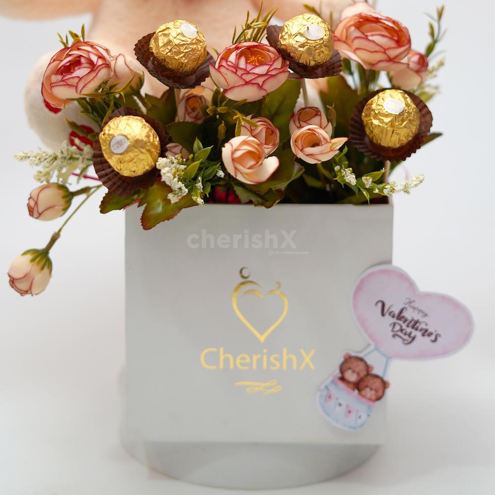 It also comes with artificial flowers that make the whole teddy day bucket look more elegant