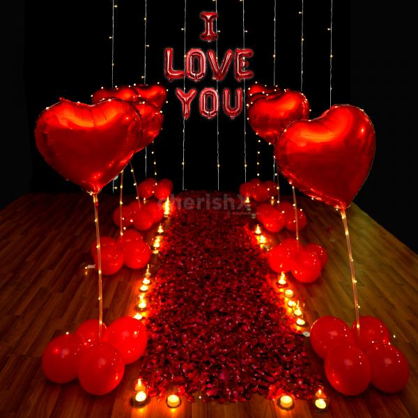 A romantic Valentine decor adorned with Rose Petals, Red Heart Balloons, and Lights