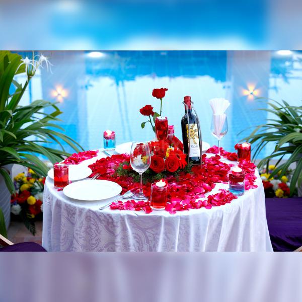 The table is adorned with flickering candles and flower petals to add more charm to your celebration.