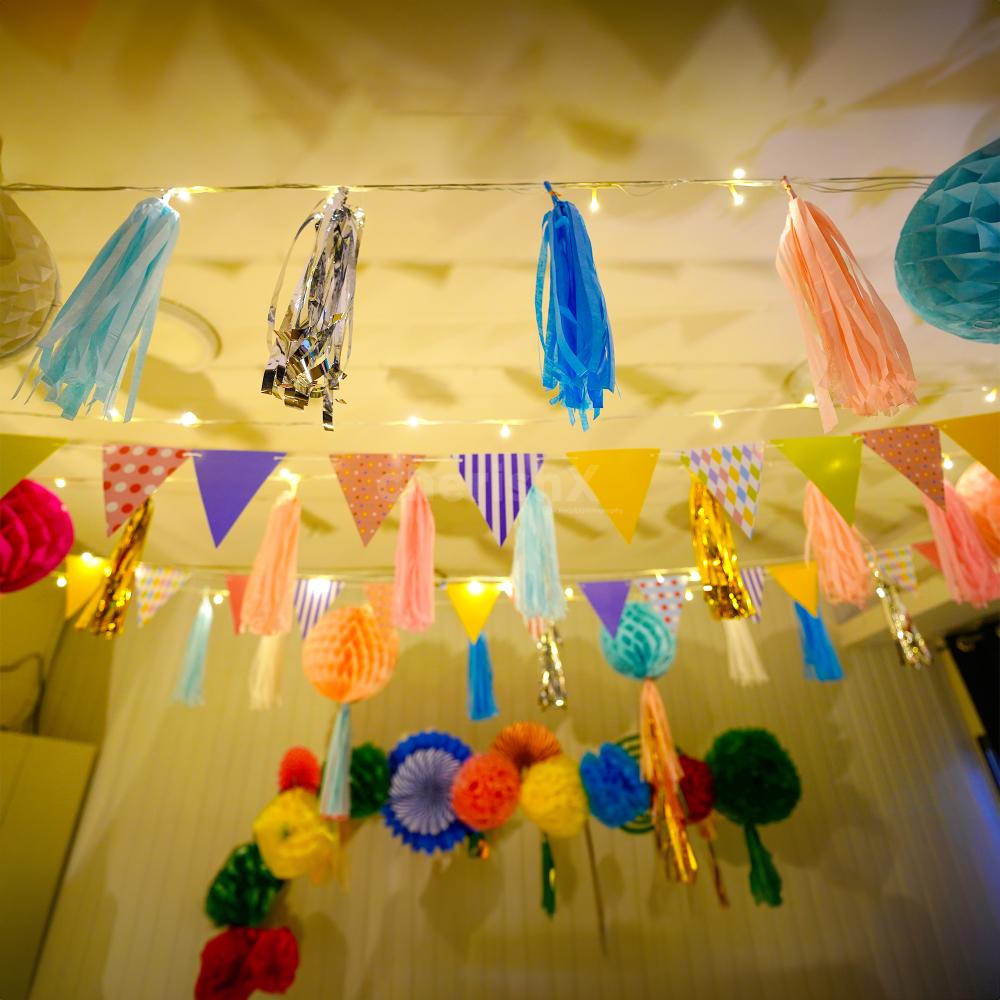 Multicoloured flag buntings are a lively addition to festive decor.