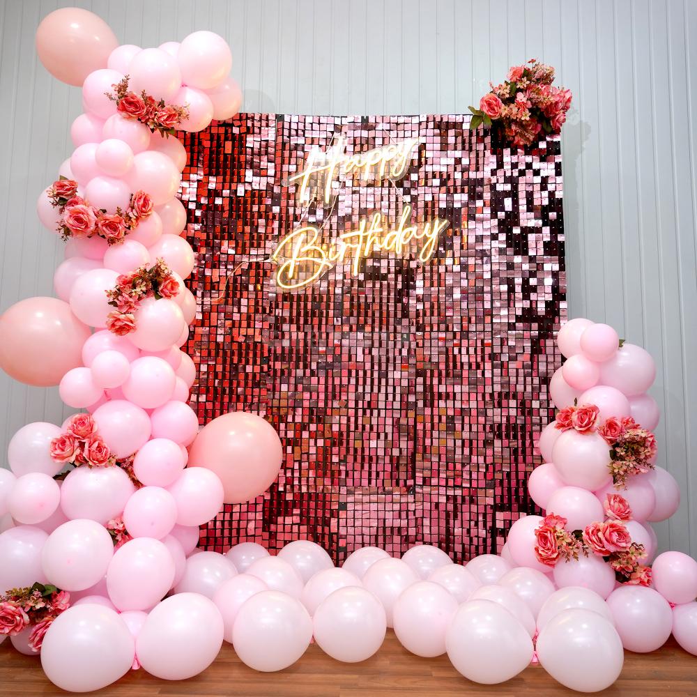 Elevate your birthday bash with our exquisite pastel pink and rose gold sequin backdrop.