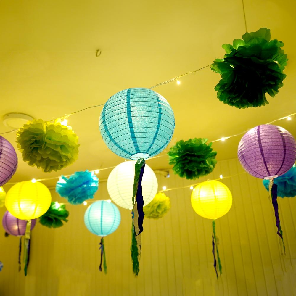 Purple, light blue, light green, and dark blue streamers, add a burst of colour to the decor.
